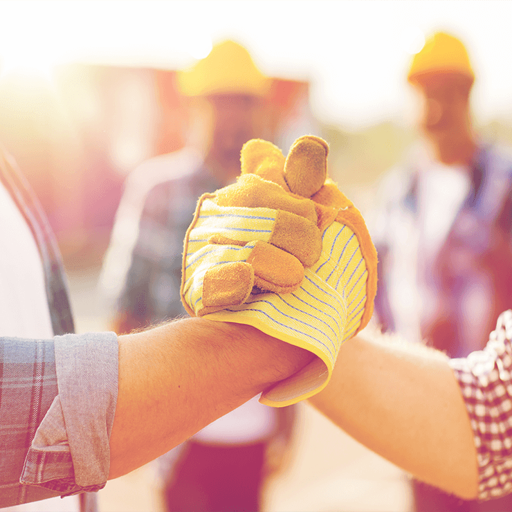 Construction workers shaking hands